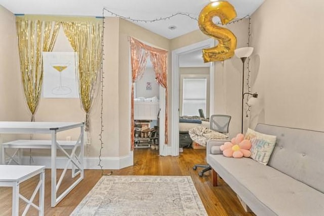 sitting room featuring wood finished floors and baseboards