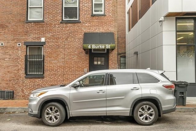 doorway to property with brick siding