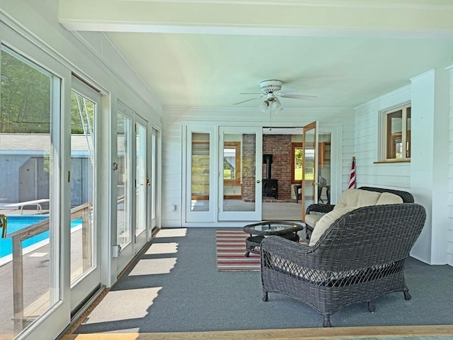 85 Warfield Rd, Charlemont, MA 01339 - sunroom / solarium featuring carpet flooring, ornamental molding, a wood stove, and french doors