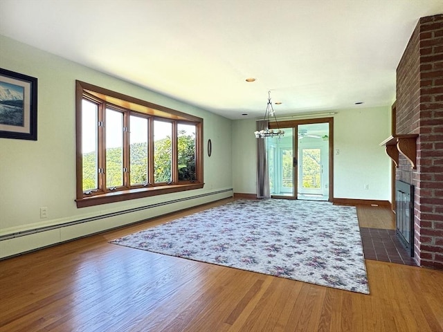 85 Warfield Rd, Charlemont, MA 01339 - unfurnished dining area with baseboard heating, a brick fireplace, healthy amount of natural light, and wood finished floors