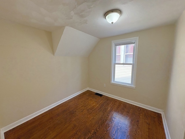 bonus room featuring lofted ceiling and hardwood / wood-style flooring