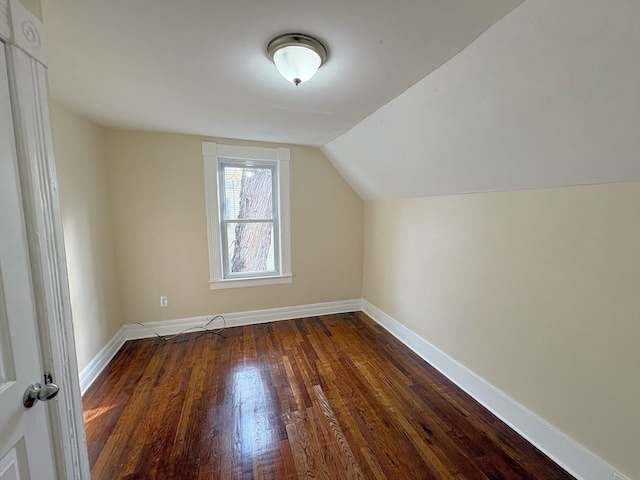 bonus room featuring dark hardwood / wood-style floors and lofted ceiling