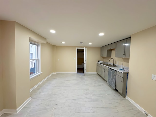 kitchen with gray cabinets, sink, and dishwasher