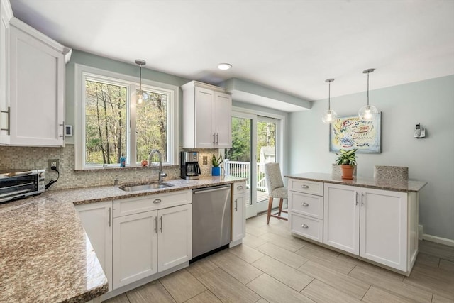 kitchen featuring a sink, white cabinetry, baseboards, backsplash, and dishwasher