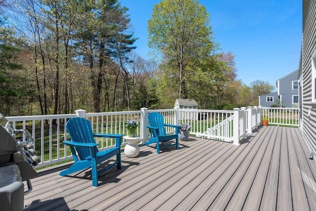 deck featuring an outdoor structure and a storage unit
