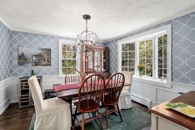 dining space with crown molding, baseboard heating, and wallpapered walls
