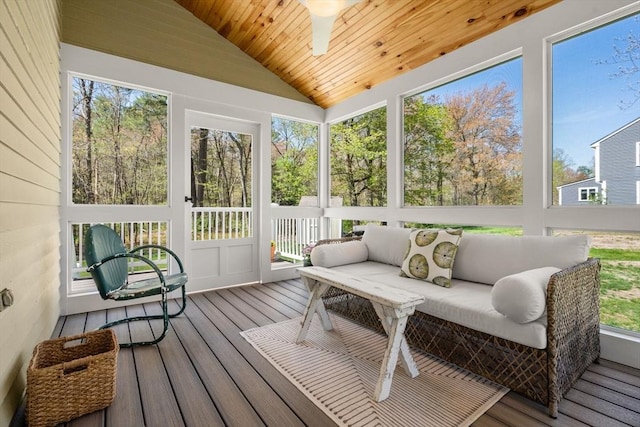 sunroom / solarium featuring ceiling fan and an outdoor living space
