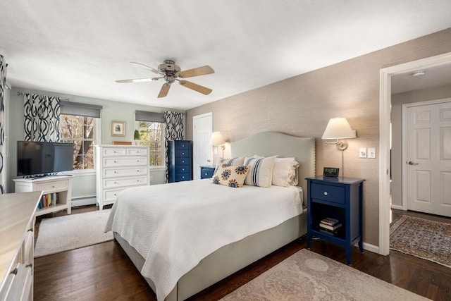bedroom featuring a ceiling fan, dark wood-style flooring, baseboards, and baseboard heating