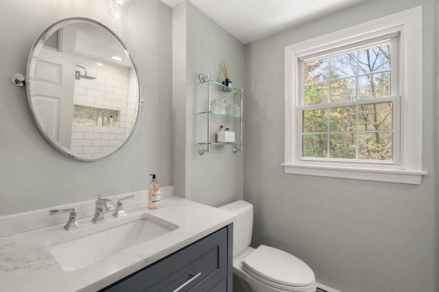 bathroom featuring toilet and vanity