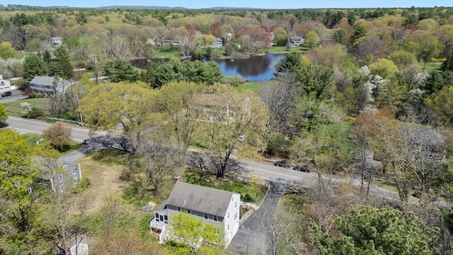 birds eye view of property featuring a water view and a forest view