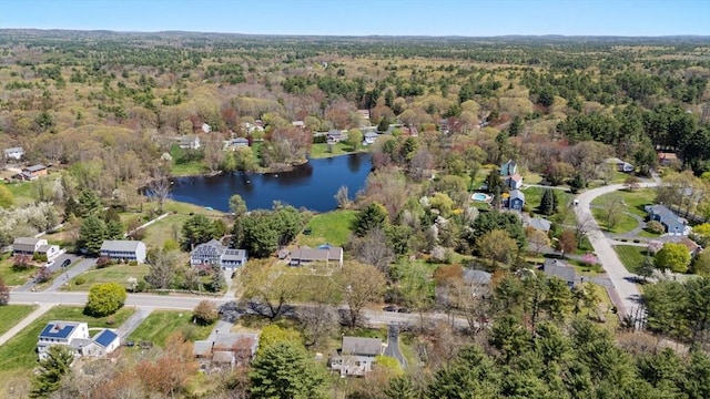drone / aerial view with a water view and a wooded view