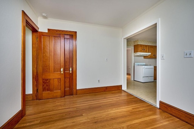 hall with light wood-type flooring, ornamental molding, and baseboards