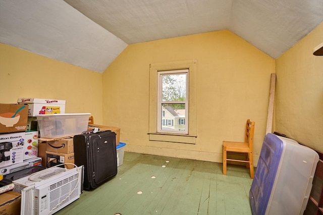additional living space featuring vaulted ceiling and hardwood / wood-style flooring