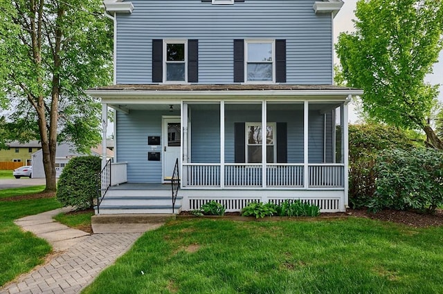 view of front of property with covered porch and a front lawn