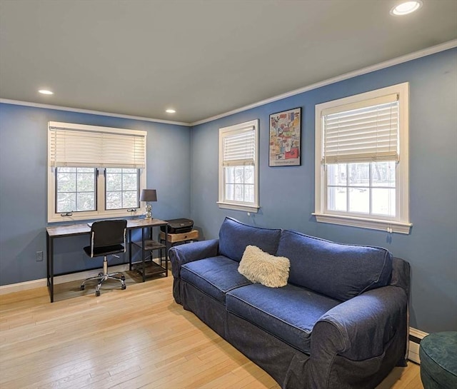 office featuring ornamental molding, baseboards, a healthy amount of sunlight, and hardwood / wood-style floors