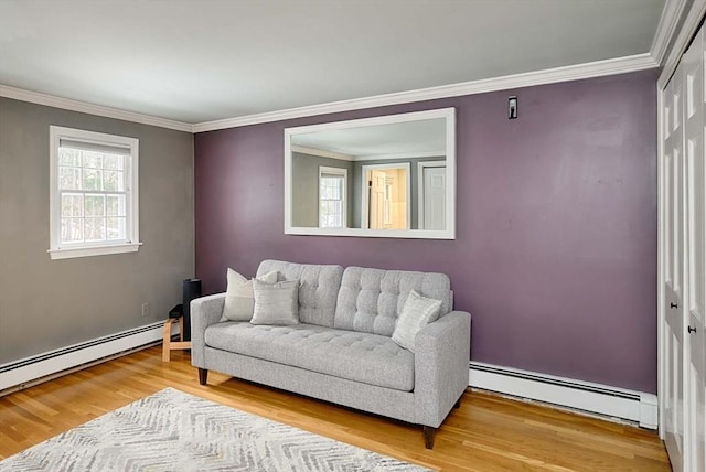 living area with a baseboard heating unit, wood finished floors, and crown molding