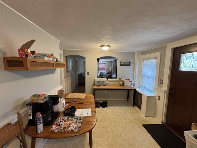 44 Cherry St Unit 2, Swampscott, MA 01907 - foyer featuring arched walkways, a textured ceiling, light flooring, and wainscoting