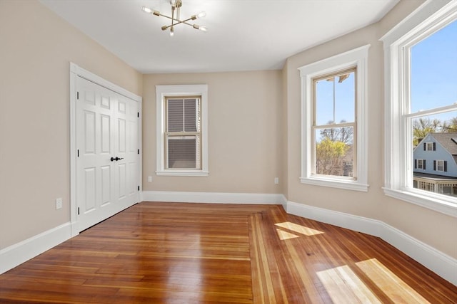 43 Ainsworth St Unit 2, Boston, MA 02131 - interior space with baseboards, a notable chandelier, and wood finished floors