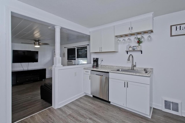 kitchen with stainless steel dishwasher, a sink, light wood finished floors, white cabinets, and a ceiling fan