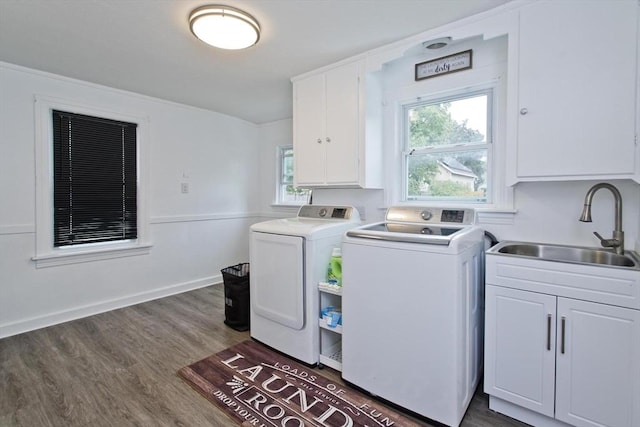 laundry room with washer and dryer, cabinet space, and dark wood finished floors