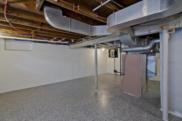 unfinished basement featuring electric panel
