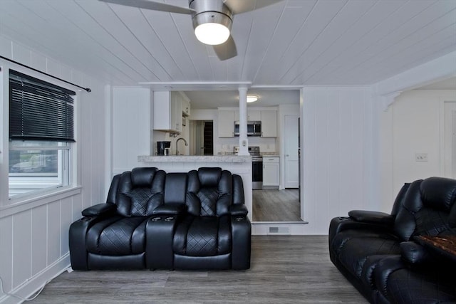 living room featuring wood finished floors, ceiling fan, and wood ceiling