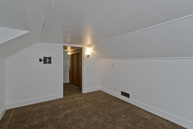 additional living space featuring carpet and vaulted ceiling