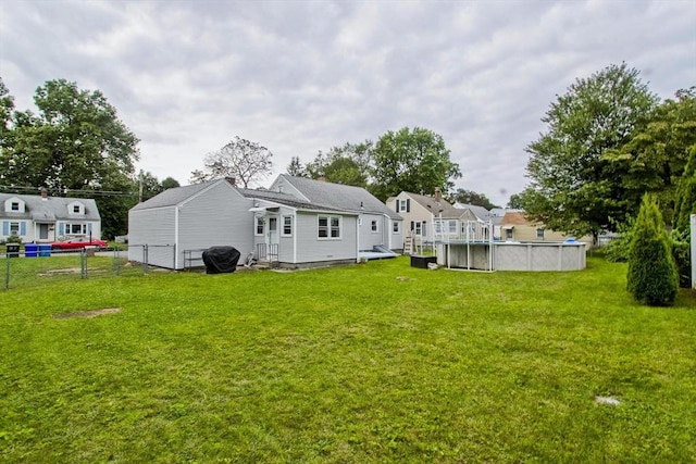 rear view of property with an outdoor pool and entry steps