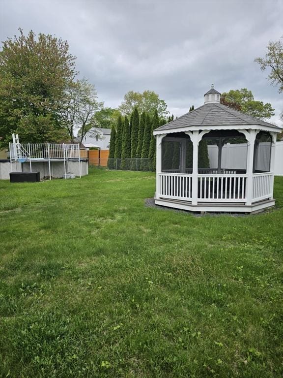 view of yard with a gazebo and an outdoor pool