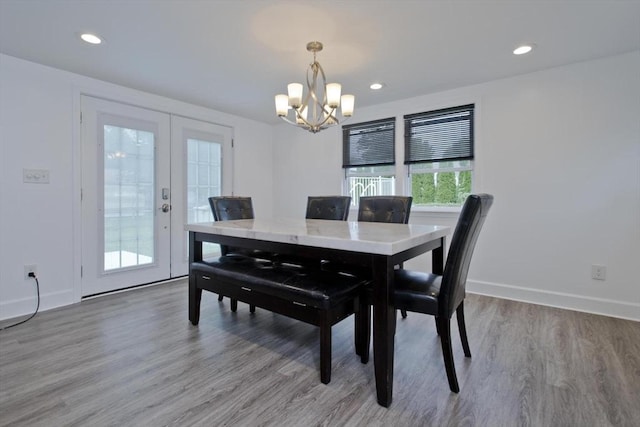 dining room with a chandelier, light wood finished floors, baseboards, french doors, and recessed lighting