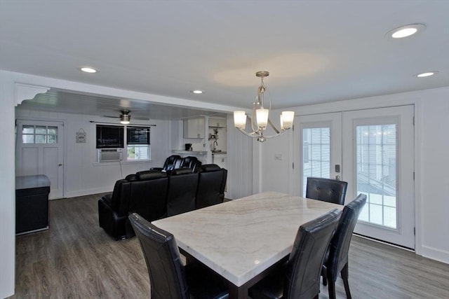 dining area with wood finished floors, plenty of natural light, french doors, a chandelier, and recessed lighting