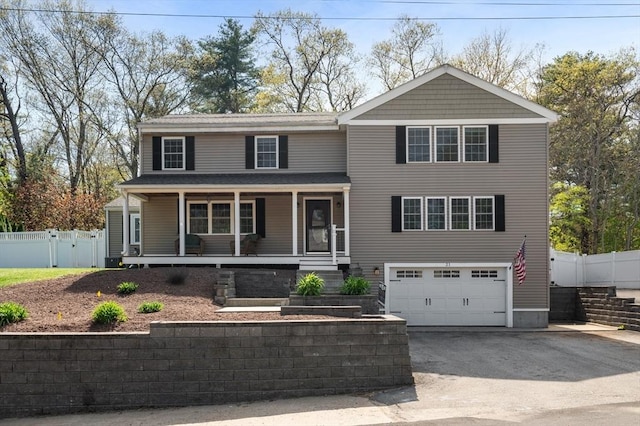21 Molloy Rd, Georgetown, MA 01833 - view of front facade with an attached garage, asphalt driveway, covered porch, and fence
