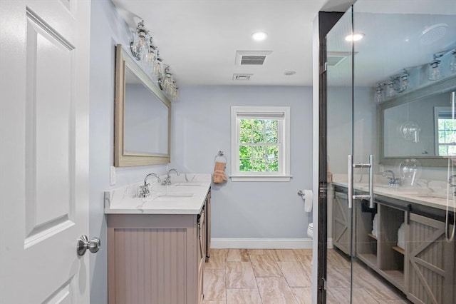21 Molloy Rd, Georgetown, MA 01833 - bathroom featuring double vanity, healthy amount of natural light, marble finish floors, and toilet