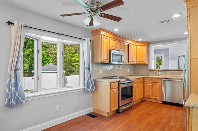 21 Molloy Rd, Georgetown, MA 01833 - kitchen featuring appliances with stainless steel finishes, healthy amount of natural light, light countertops, light wood-type flooring, and recessed lighting