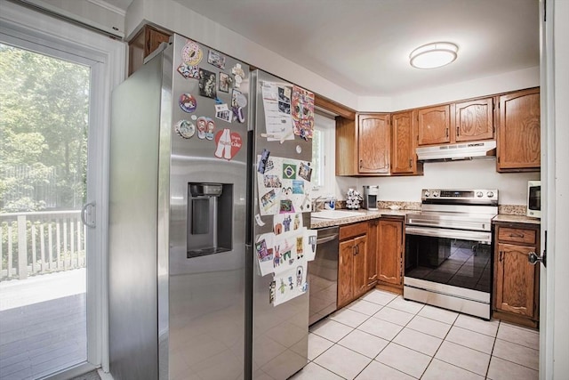 40 Sharron Dr Unit 40, Easton, MA 02375 - kitchen featuring stainless steel appliances, under cabinet range hood, brown cabinetry, light countertops, and light tile patterned floors
