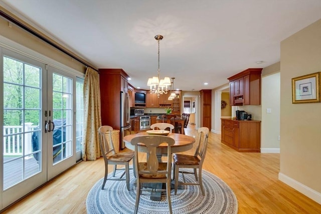 dining area featuring a chandelier, french doors, light wood-style flooring, baseboards, and recessed lighting