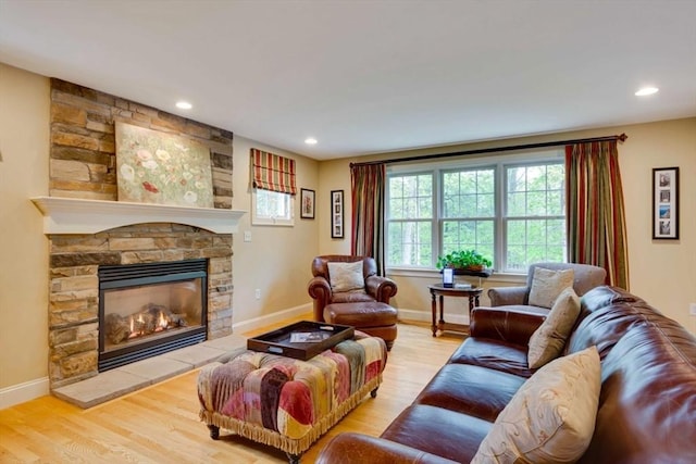 living area with wood finished floors, a fireplace, baseboards, and recessed lighting