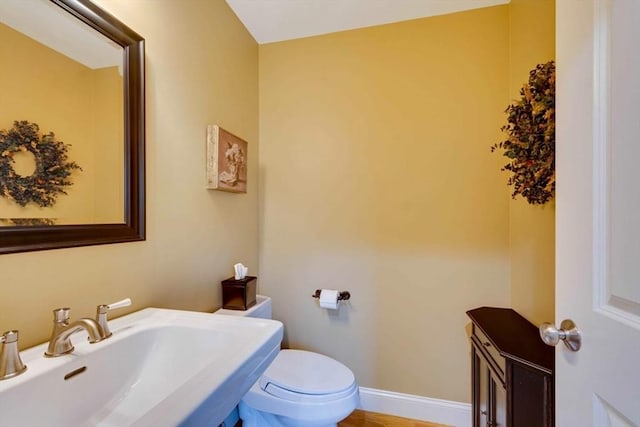 bathroom featuring a sink and toilet