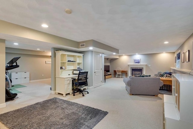 carpeted living area with recessed lighting, a desk, a fireplace, and baseboards
