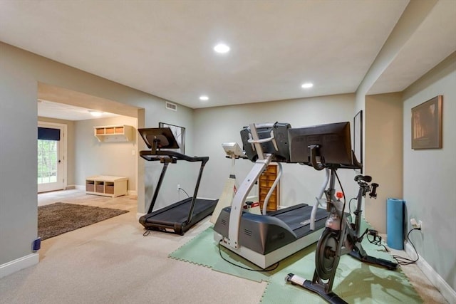 exercise room featuring carpet, recessed lighting, baseboards, and a wall mounted air conditioner
