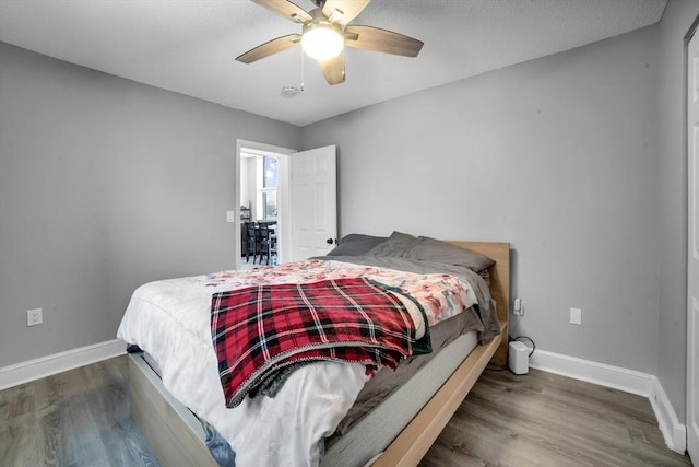 bedroom with ceiling fan and wood-type flooring