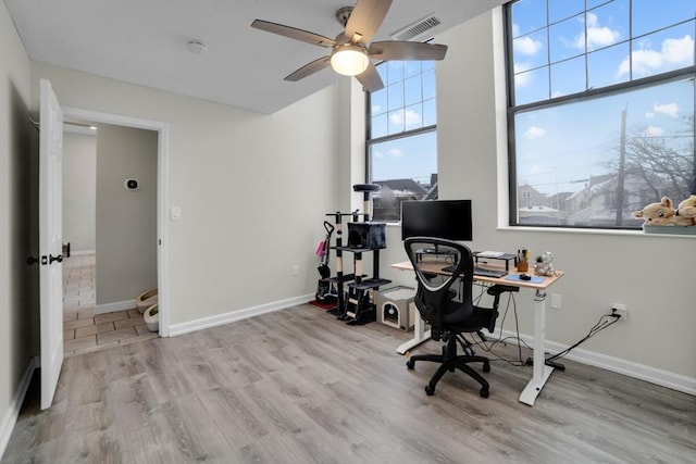 office space with light wood-type flooring and ceiling fan