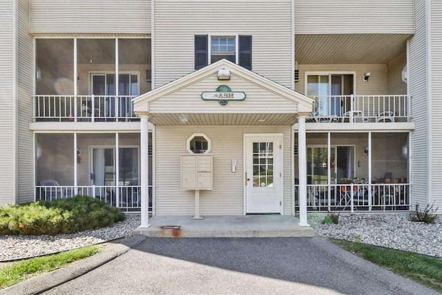 view of exterior entry featuring a porch