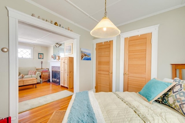 bedroom featuring crown molding and wood-type flooring