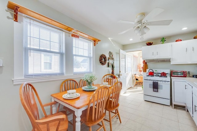 kitchen with white cabinetry, gas range gas stove, and ceiling fan