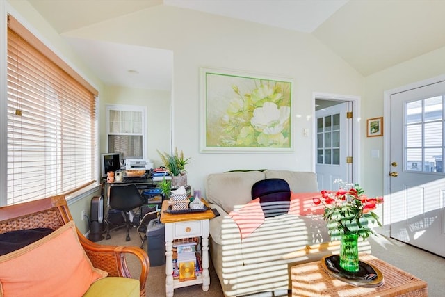 living room featuring carpet floors and vaulted ceiling