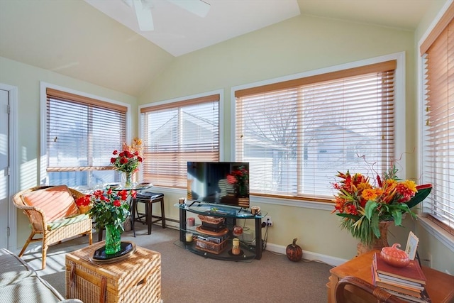 sunroom with vaulted ceiling, ceiling fan, and a baseboard radiator