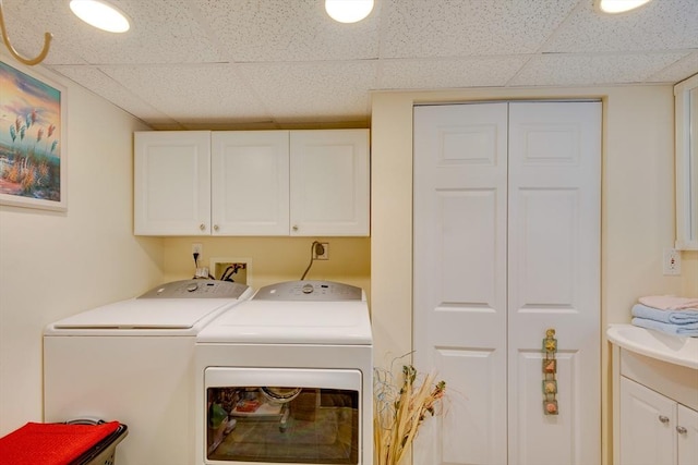 laundry room with cabinets and washer and dryer