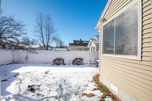 view of yard layered in snow