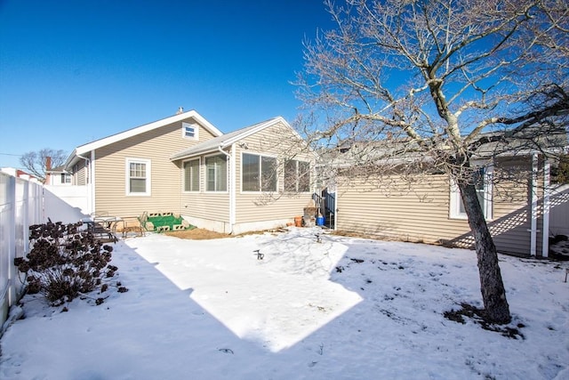 view of snow covered back of property